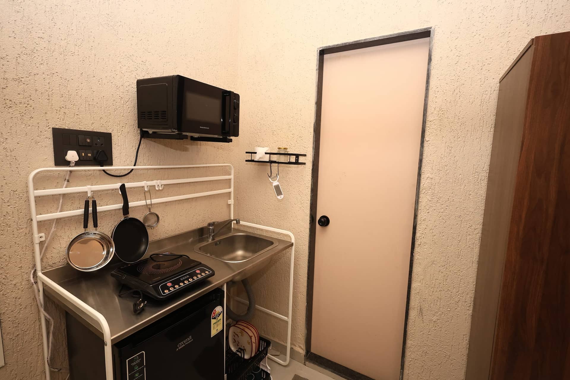 In-room kitchenette with microwave, induction cooktop and sink
