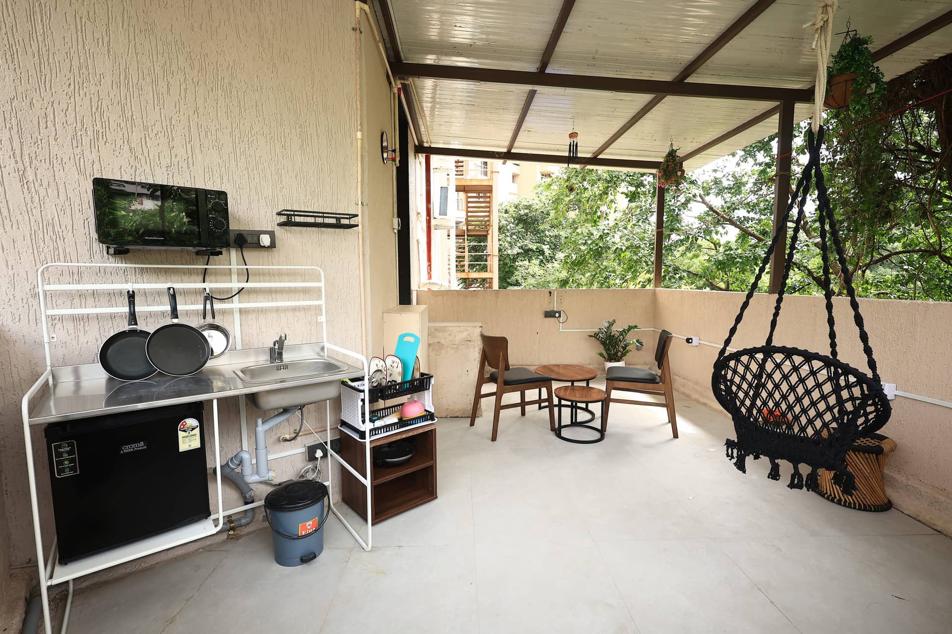 Open-air kitchenette and hanging chair on the Hinata terrace