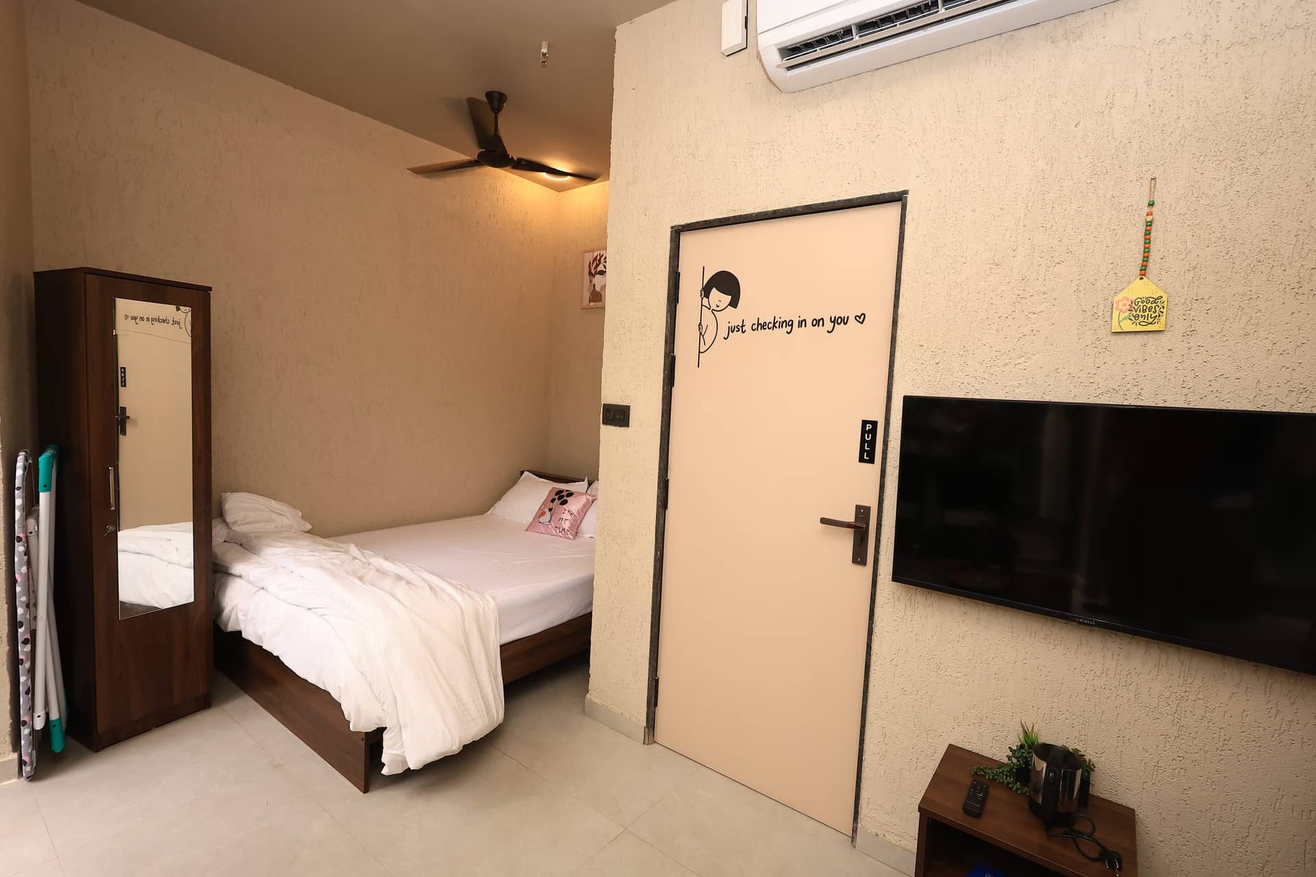 Kizuna interior with wall-mounted TV and illustrated door