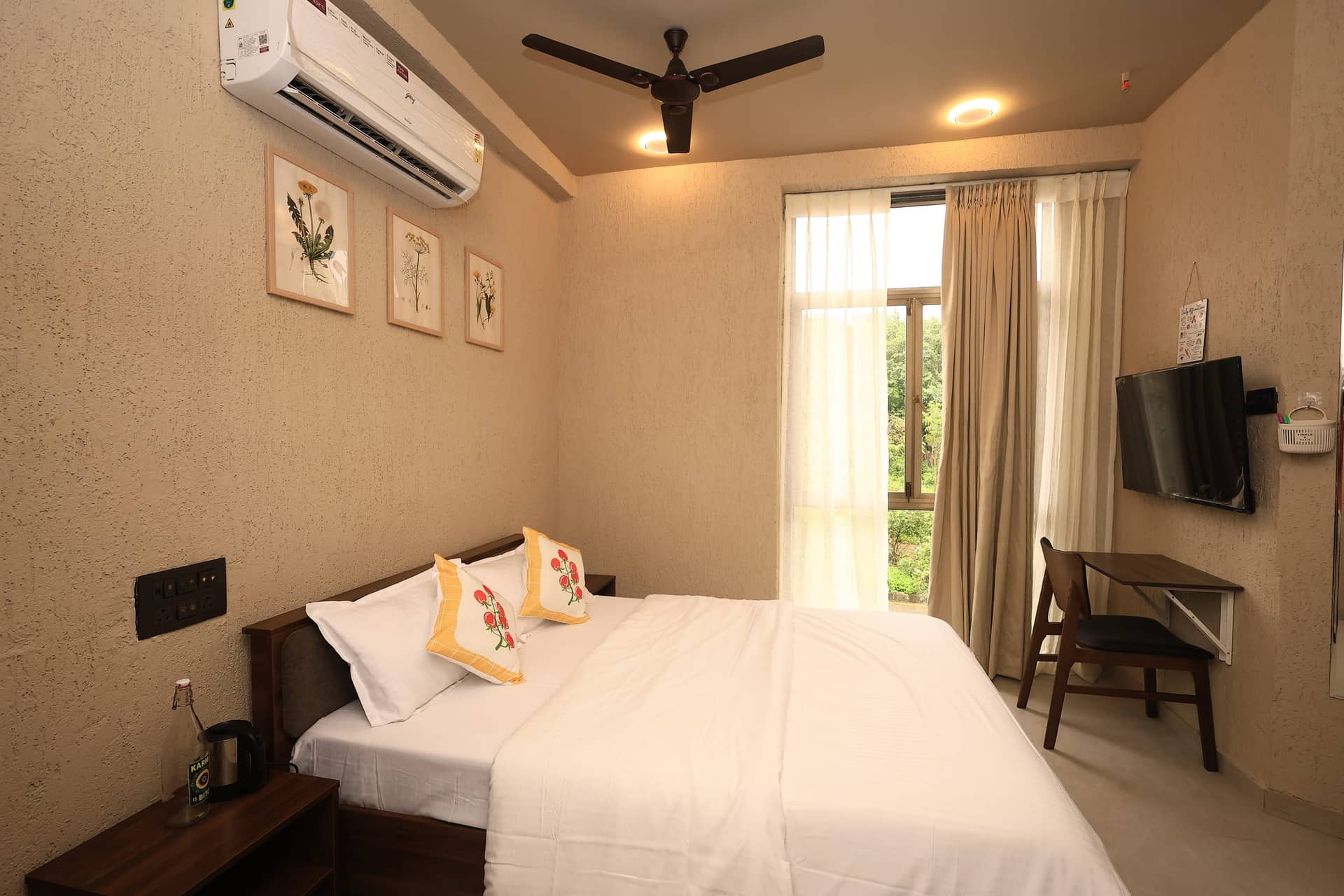 Liora bedroom with green view through the window