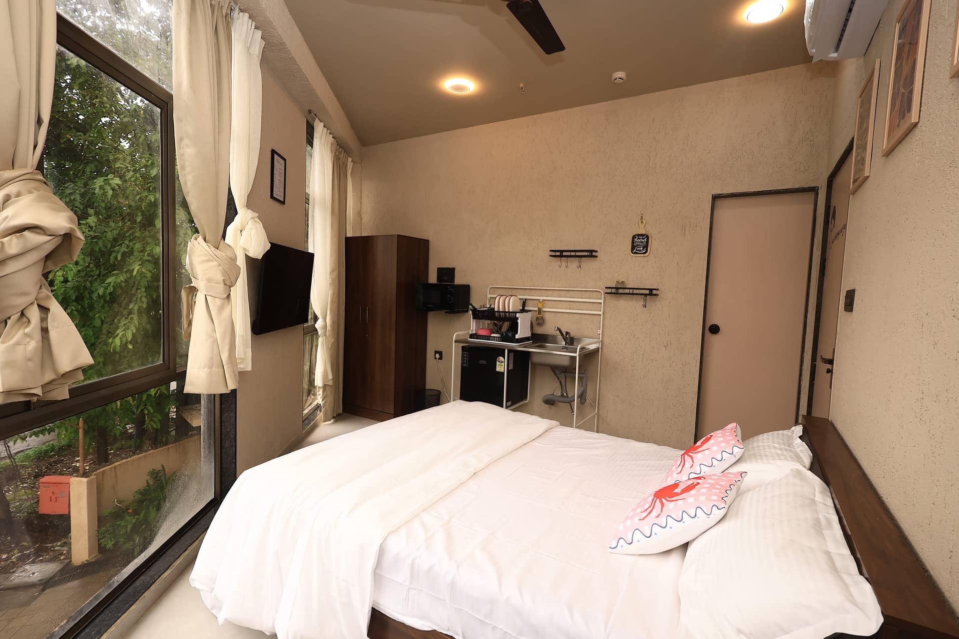 Mikami bed beside a bright garden-facing window