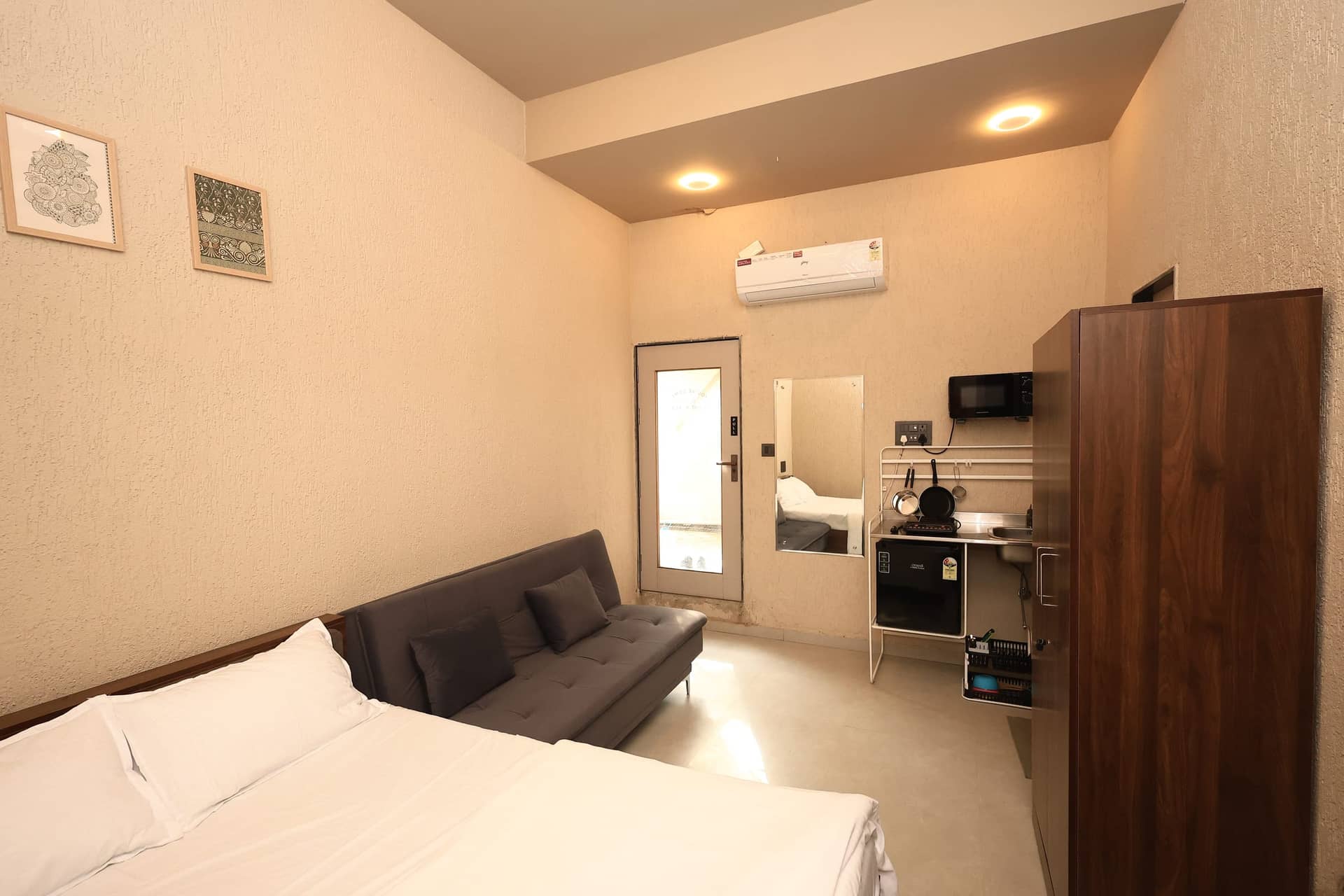 A spacious Inaari studio with a sofa and kitchenette