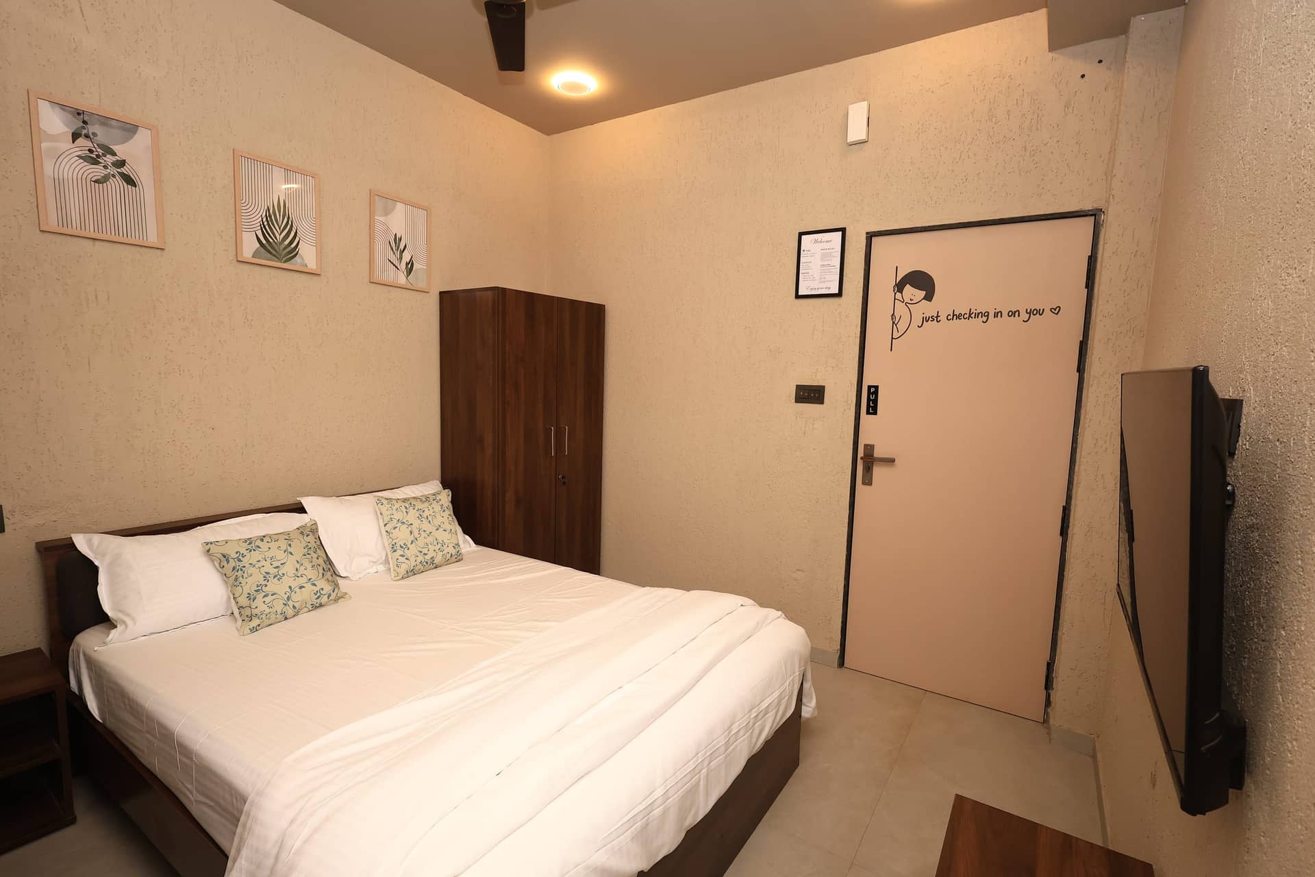 Ojani bedroom framed by botanical artwork
